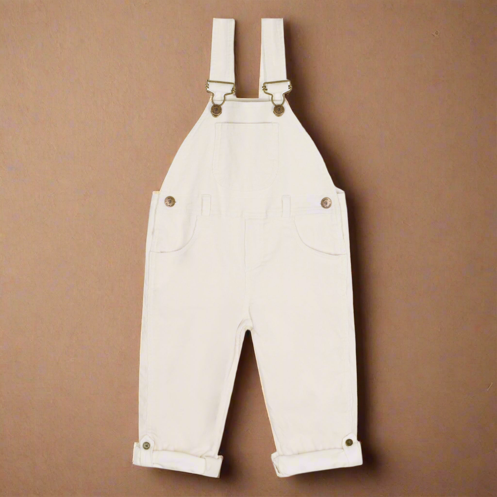 White corduroy children's dungarees with gold/brass coloured buttons