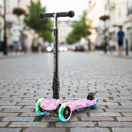 Children's scooter with pink deck and colourful wheels on a city street