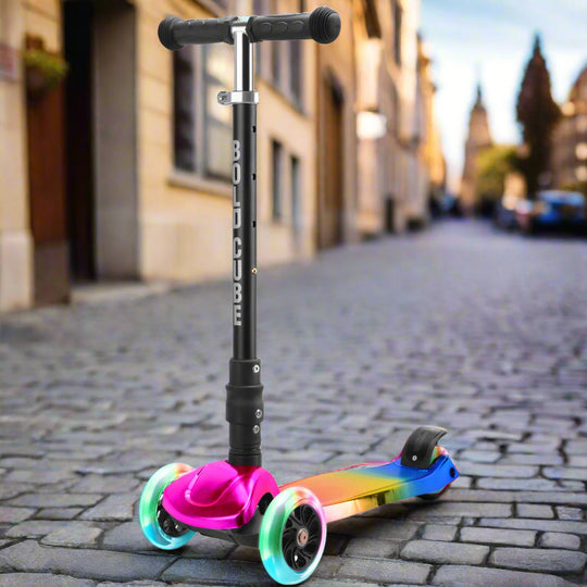 Children's three wheeled scooter with black handles and a black vertical bar with 'Bold Cube' written down it and a colourful tread with glowing colourful wheels