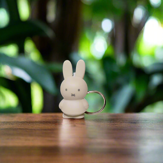 Beige rabbit-shaped keyring with iconic cross stitched mouth