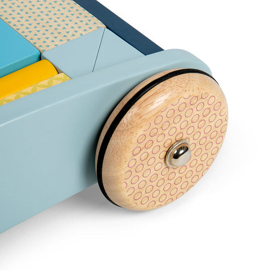 Close up pf wooden wheel with rubber edging on it as a safety mechanism to stop walker from going too fast