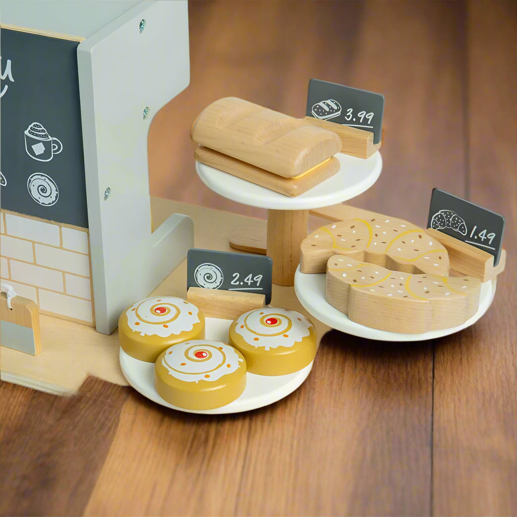 Close up of wooden sweet treats for sale, such as pastries and cinnamon buns