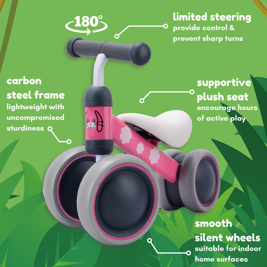 Pink balance bike with features highlighted on a green background such as limited safety sterring, carbon steel frame, supportive seat and smooth silent wheels