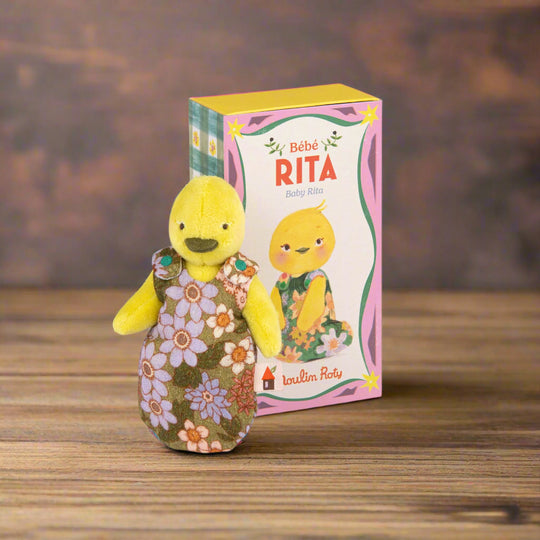 Yellow plush toy duck with a floral sleepsack next to its decorative packaging box labeled 'Bebe Rita'