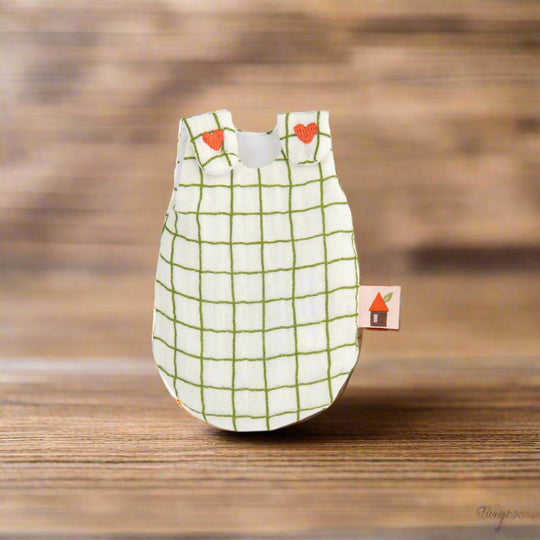 White sleepsack with green grid pattern and red embroidered hearts