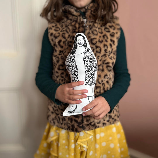 A child holiding screen printed doll cushion of Allison Hammond