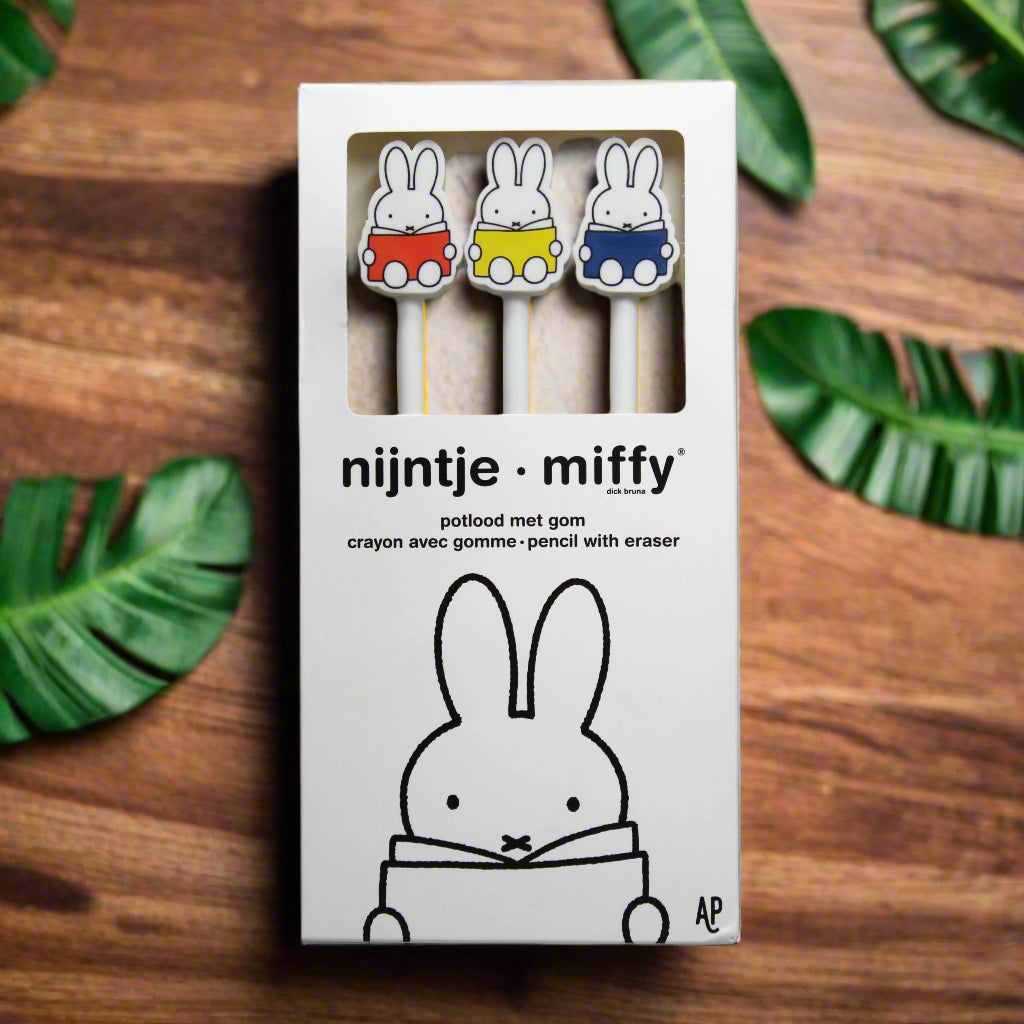 Packaging of three Miffy pencils with erasers, the erasers shaped like a Miffy bunny reading a book, with three different book colours - red, yellow and blue