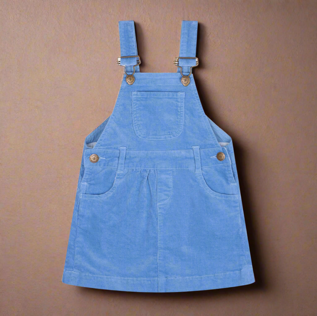 Corduroy dress in a mid blue resembling the colour of forget-me-not flowers, with two pockets either side and one central pocket on the chest, with brass buttons