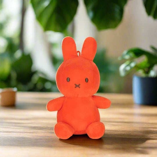 Bright orange plush stuffed toy rabbit with iconic cross stitched mouth