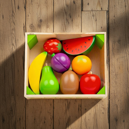 Colorful wooden toy fruits in a box on a white background