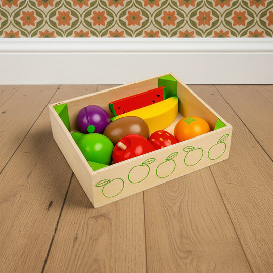 Set of colorful wooden fruits and vegetables in a box on a white background