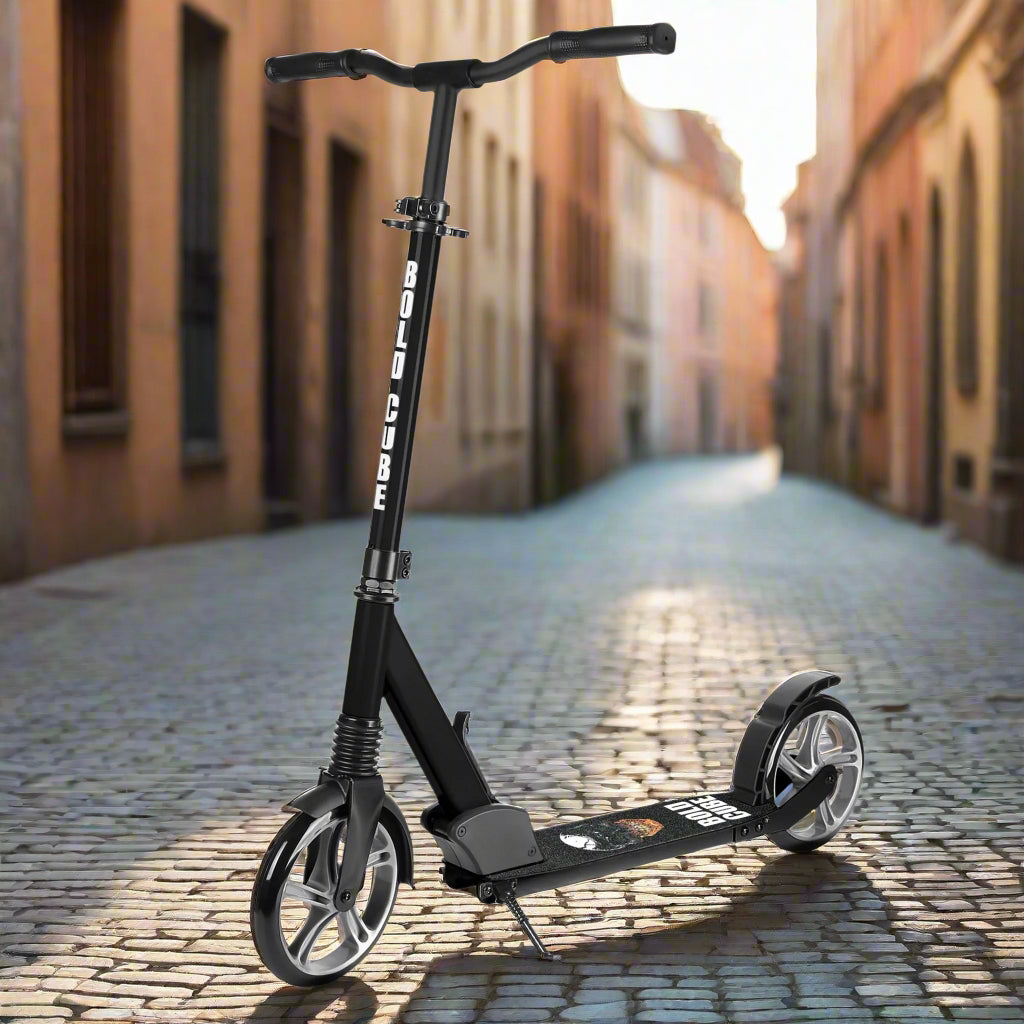 Black scooter with large wheels and a small kick stand to keep it upright and 'Bold Cube' written down the vertical bar in white capital letters