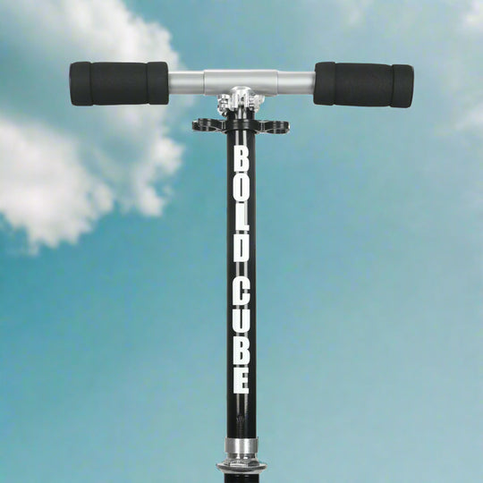 Close up of scooter handlebars showing padded handles against a blue sky background