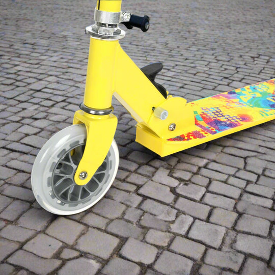 Close up of yellow scooter from wheel which is transparent and showing colourful design on the tread of the scooter