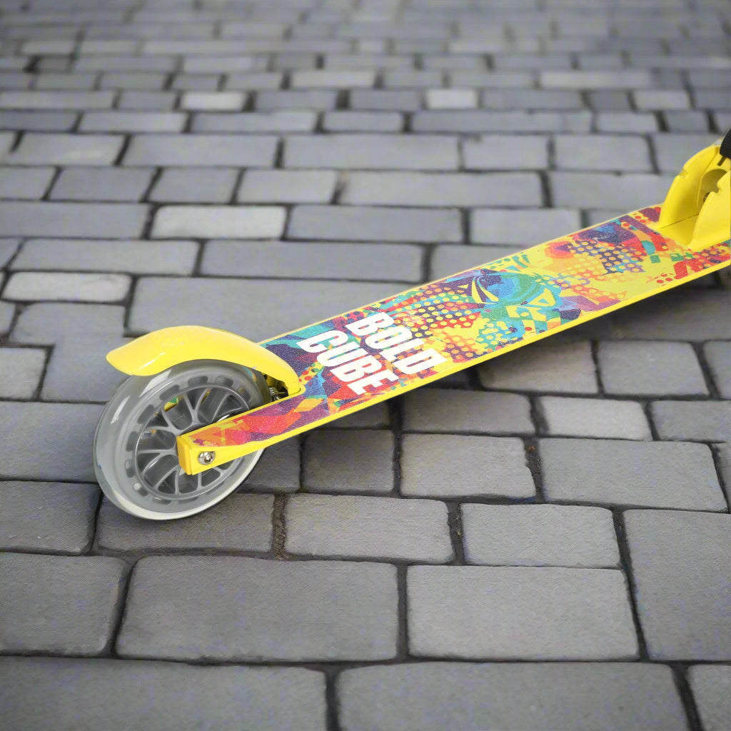 Close up of rear wheel which is transparent and more detail of the tread of the scoother which shows a colourful design and 'Bold Cube' logo