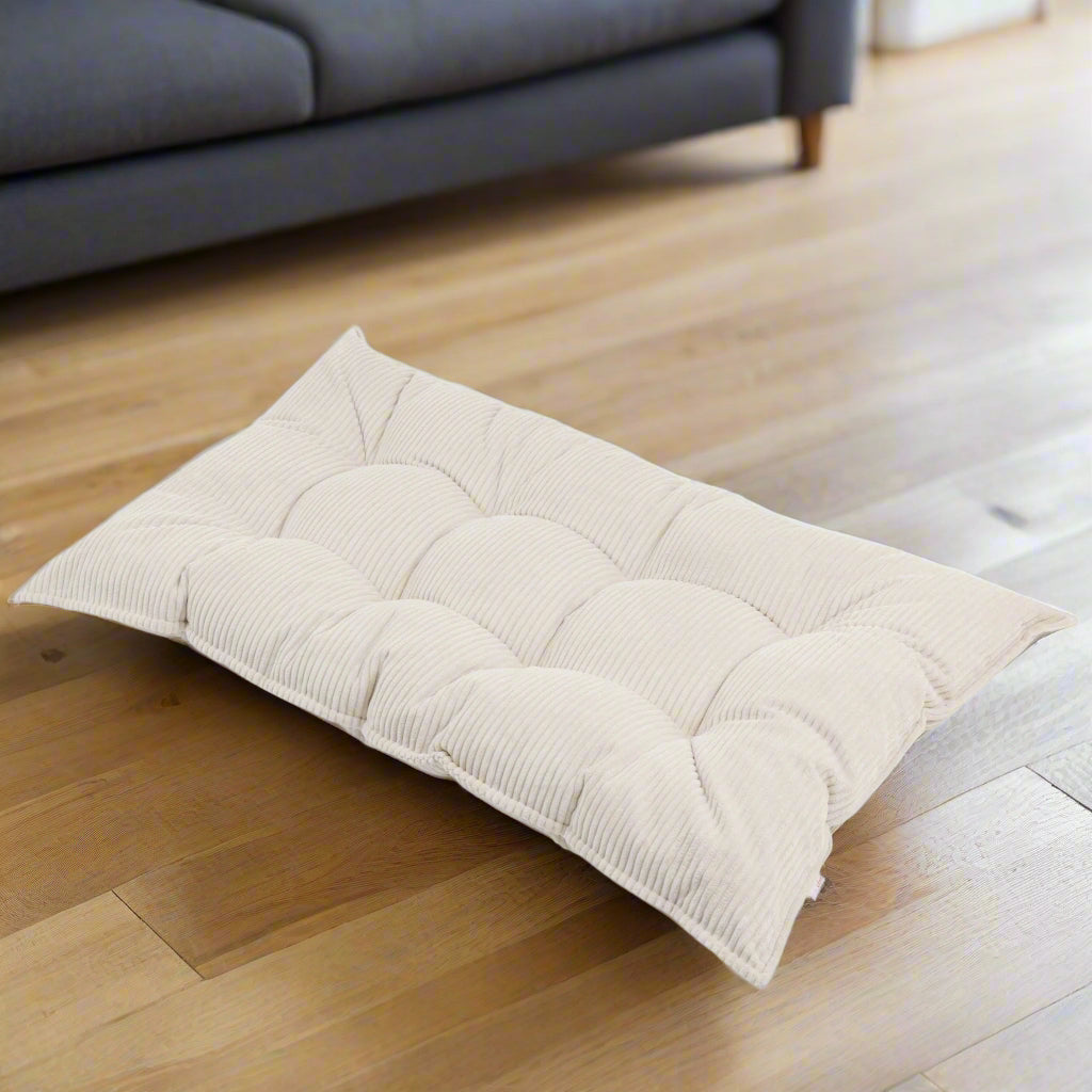 Beige coloured rectangular floor cushion with a chunky striped corduroy fabric and buttons