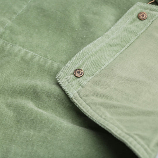 Close-up of green fabric with button details