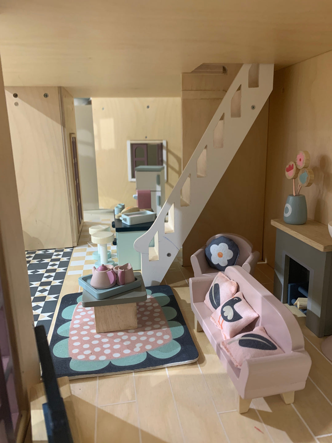 Children's playroom with a small sofa, rug, and decorative items.