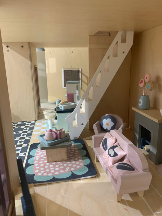Children's playroom with a small sofa, rug, and decorative items.