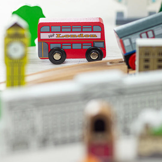 Close up of a red London double decker bus with 'Visit London' written on the side
