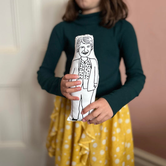 Child holding screen printed doll of Sandi Toksvig