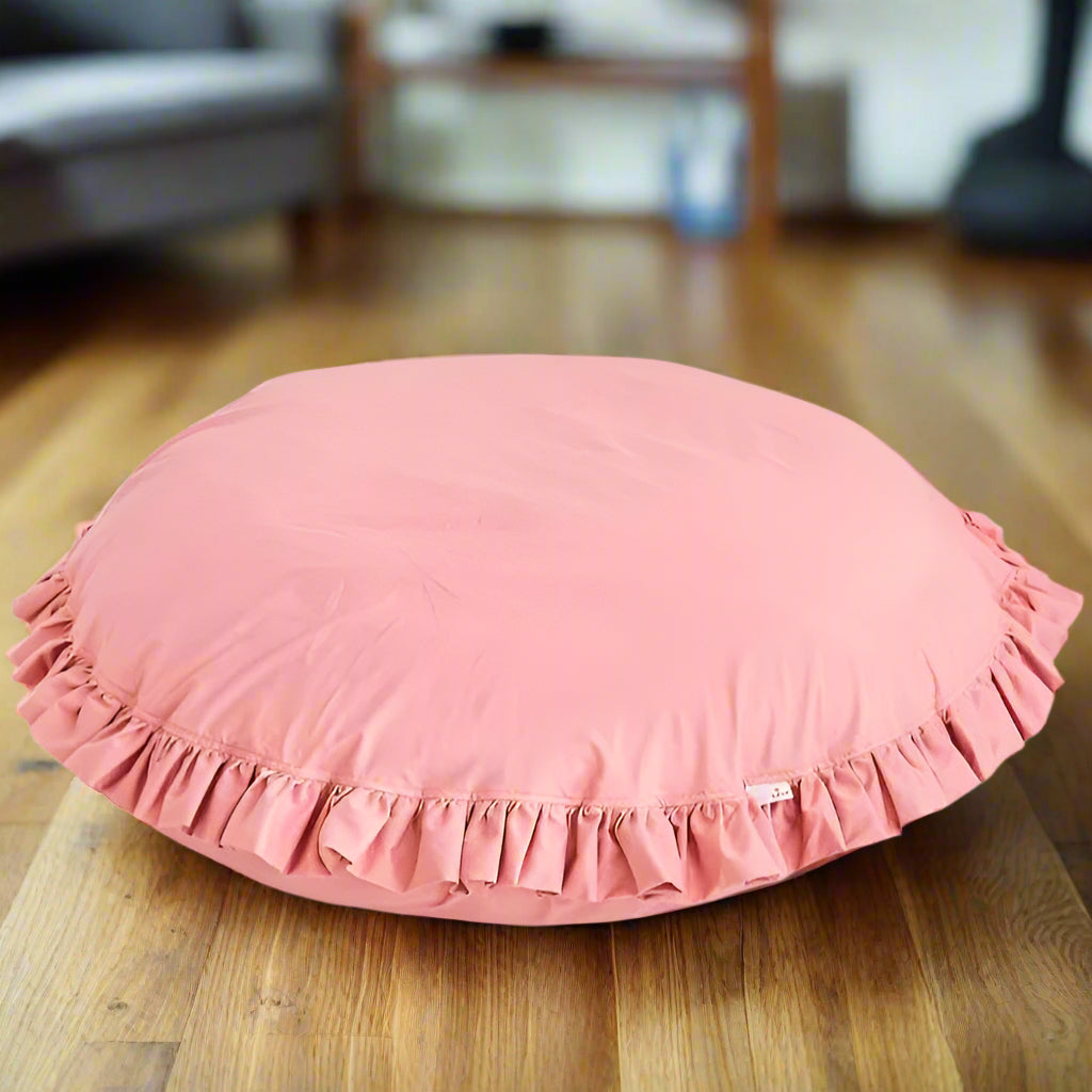 Pink round floor pillow with ruffled edge