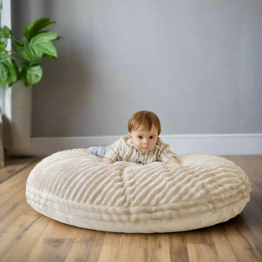 Young child sitting on corduroy floor cushion