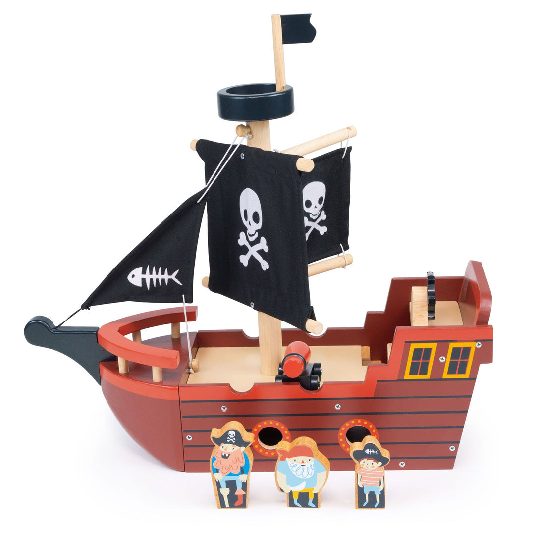 Wooden toy pirate ship with black flag featuring a skull and crossbones on a white background