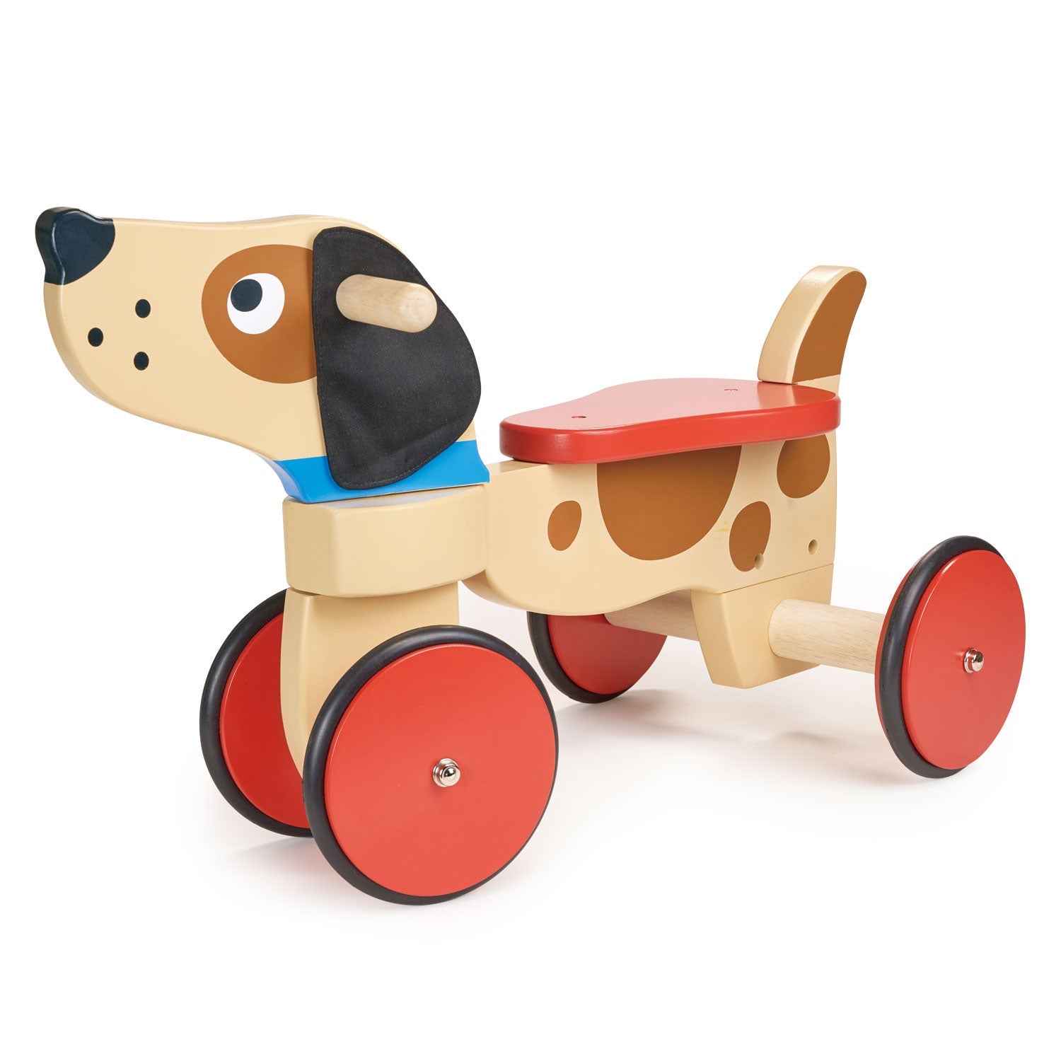 Wooden toy ride-on dog with brown spots, black ears and red wheels on a white background