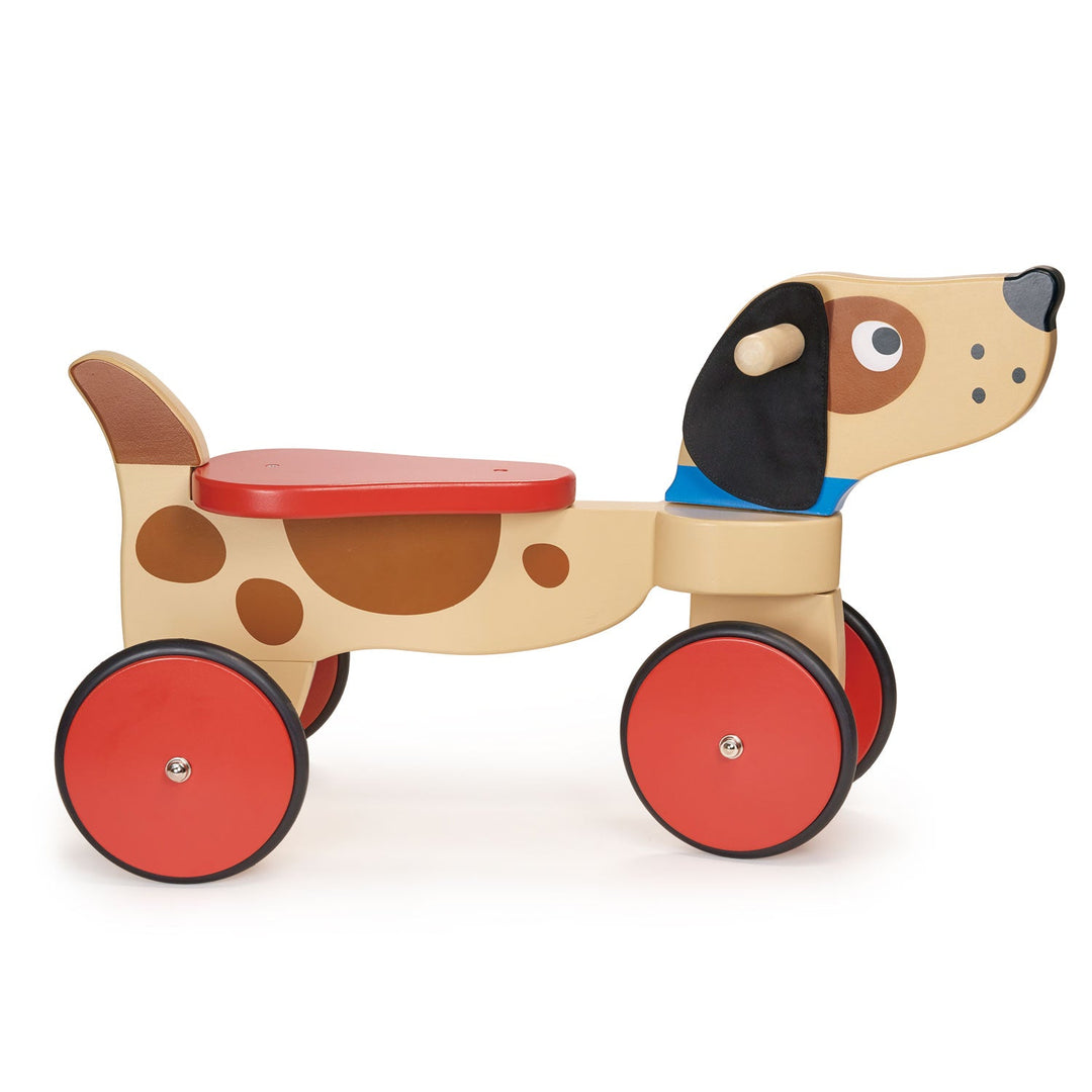 Wooden toy dog with red wheels on a white background