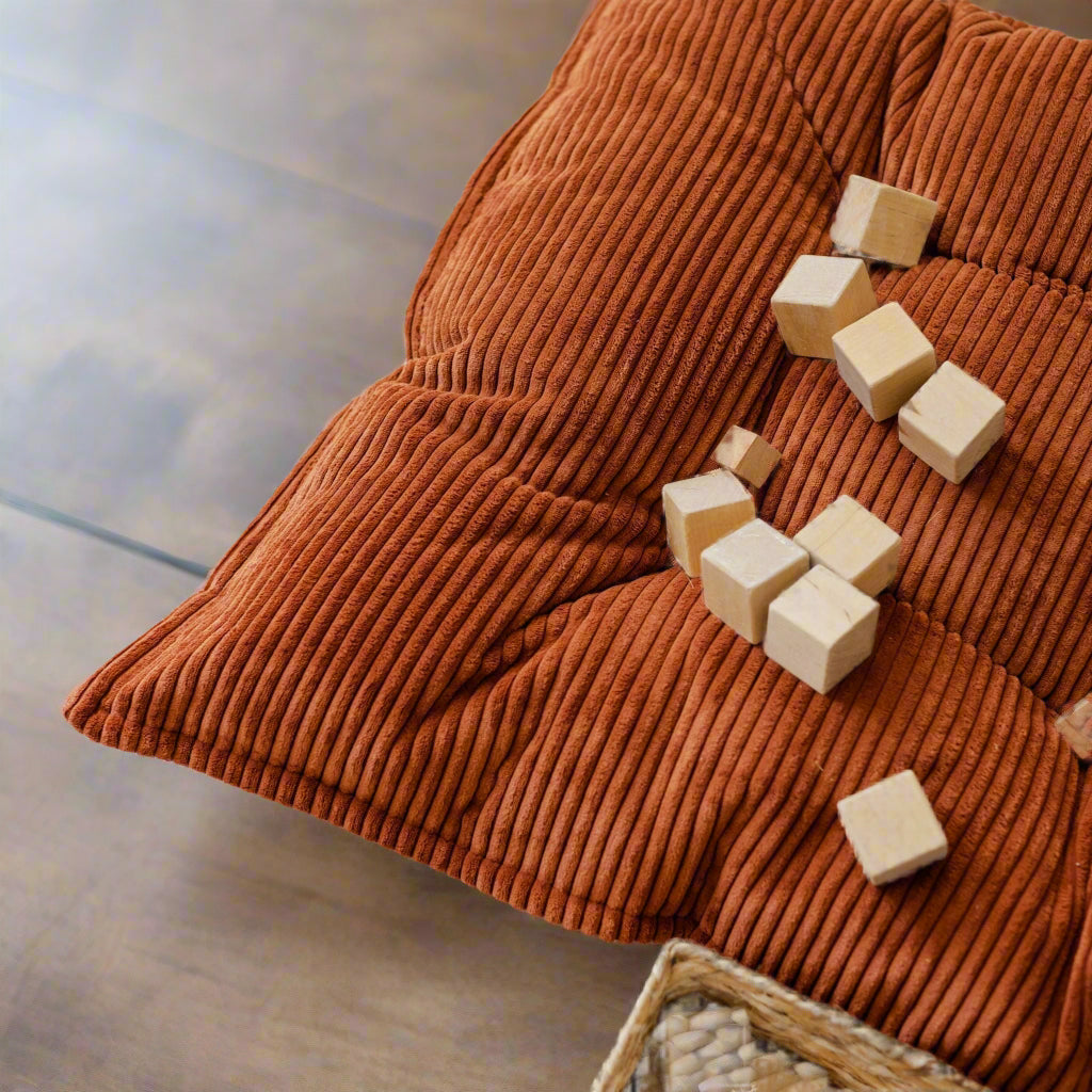 close up of brown floor cushions showing the ribbed chunky corduroy fabric in detail
