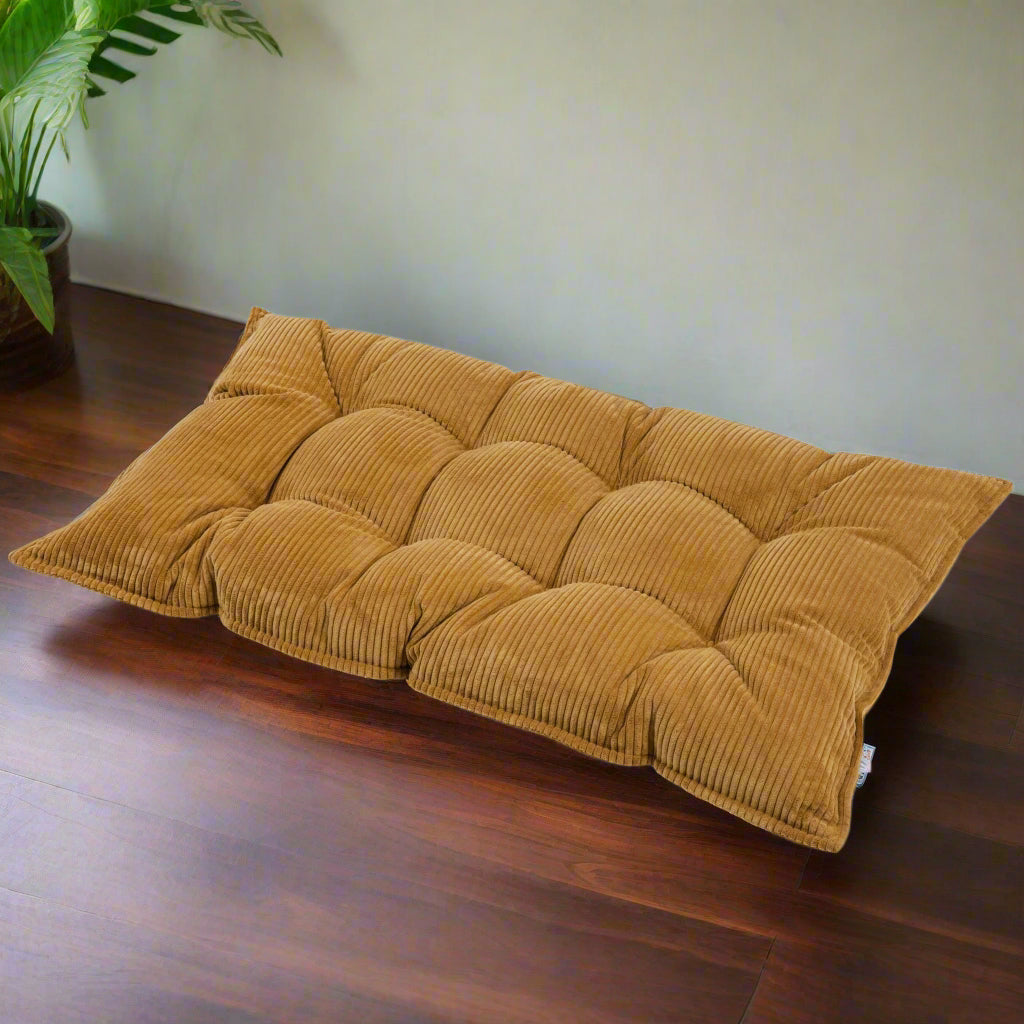 Mustard yellow coloured rectangular shaped floor cushion with buttons and a chunky corduroy fabric