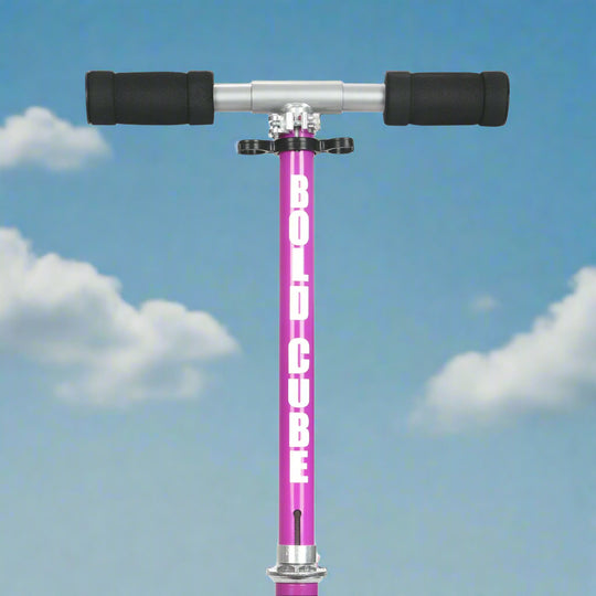 Close up of handlebars showing thick black foam handles and 'Bold cube' written on vertical purple bar
