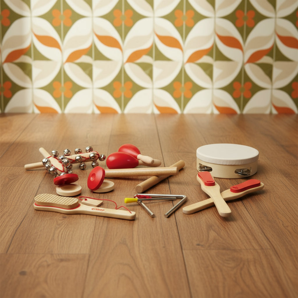 A collection of wooden musical instruments for kids, including a tambourine, castanets, maracas, paddles, rhythm sticks, scraper, bells, and triangle, all with red detailing.