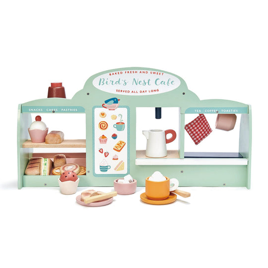 Toy bakery set with various items on a white background