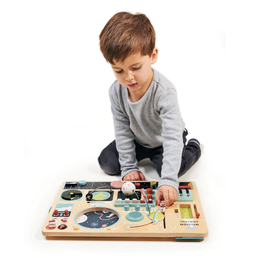 Child playing with a wooden toy on a white background