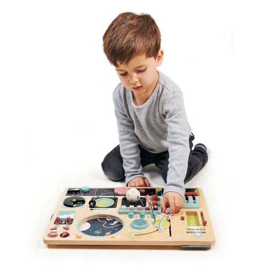 Child playing with a wooden toy on a white background
