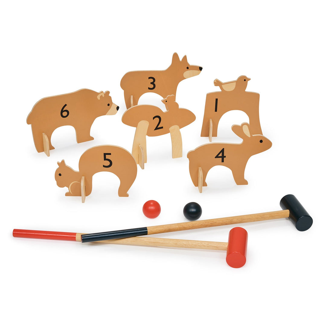 Wooden animal croquet set with numbered pieces and mallets on a white background