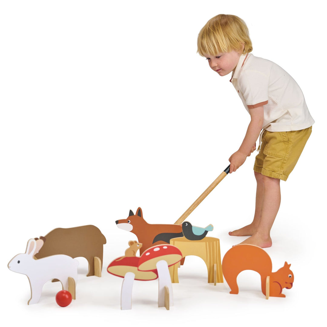 Child playing with wooden animal toys on a white background