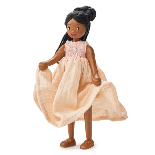Doll with a pink top and beige dress on a white background