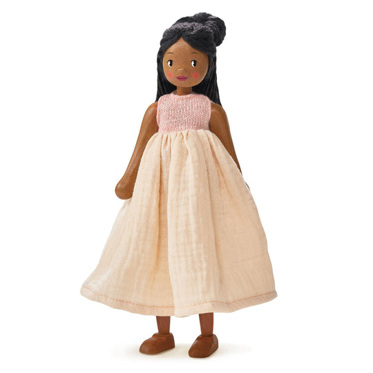 Brown doll with black hair wearing a pink and beige dress on a white background