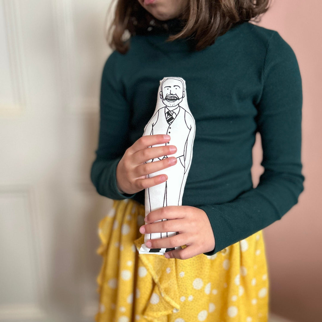 A child holding screen printed doll cushion of Gareth Southgate