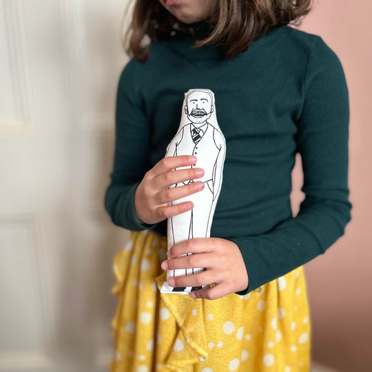 A child holding screen printed doll cushion of Gareth Southgate