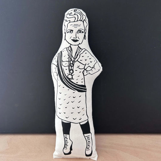 Screen printed black and white doll depicting Vivienne Westwood in a patterned dress with her hands on her hips