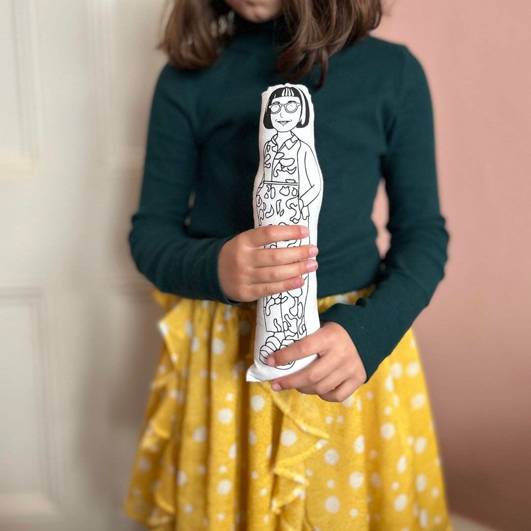 A child holding the screen printed doll cusion of Philippa Perry