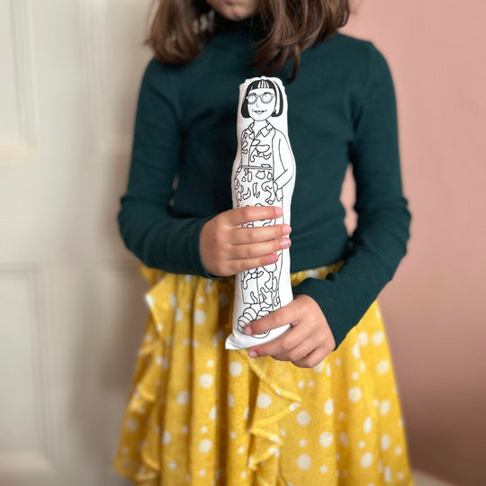 A child holding the screen printed doll cusion of Philippa Perry