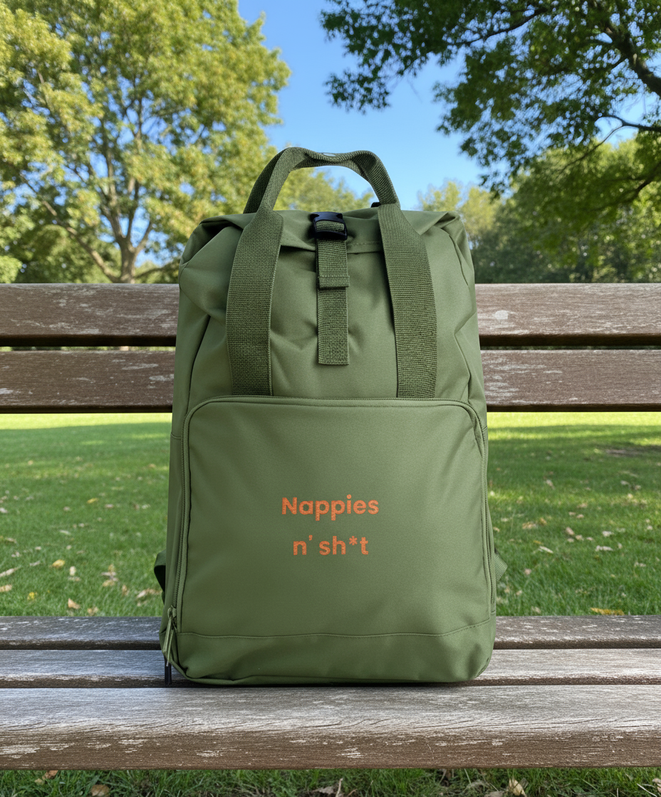 Green backpack with text on a wooden bench in a park