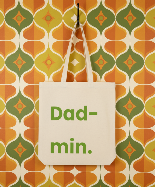 Tote bag with 'Dad-min.' text on a patterned wall background