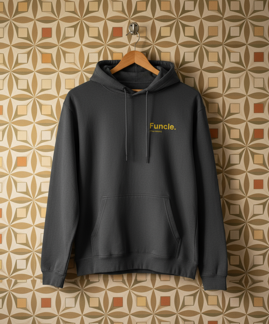 Dark grey hoodie with 'Funcle' text on a hanger against a patterned wall.