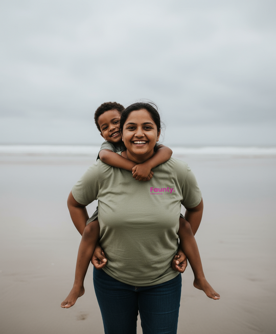 Woman carrying a child on her shoulders with a cloudy sky background
